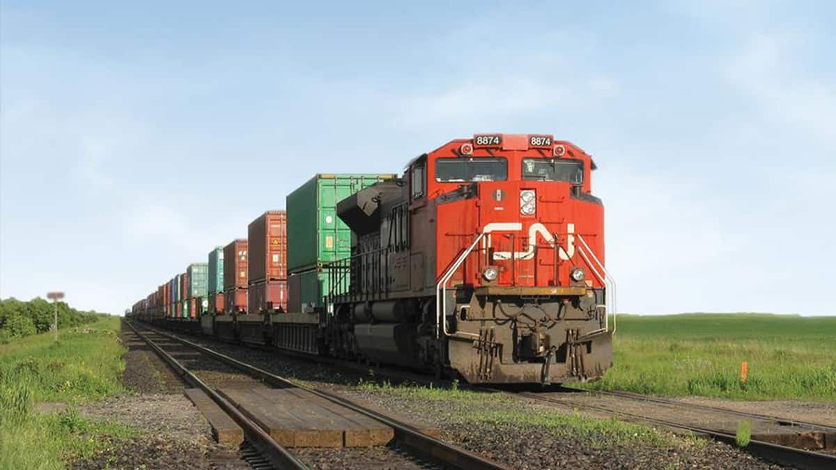 A photograph of a CN train crossing a field.