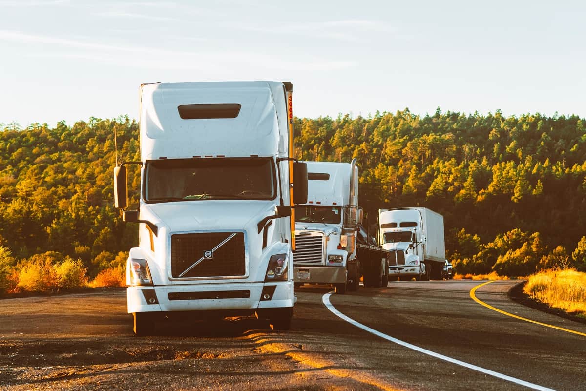 White truck convoy road forest roadside - stock - credit Quintin Gellar and Pexels