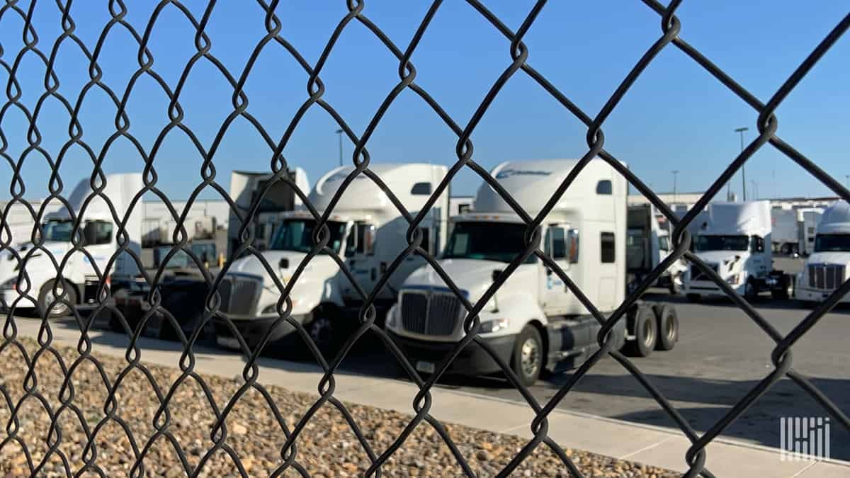 Used trucks behind fence