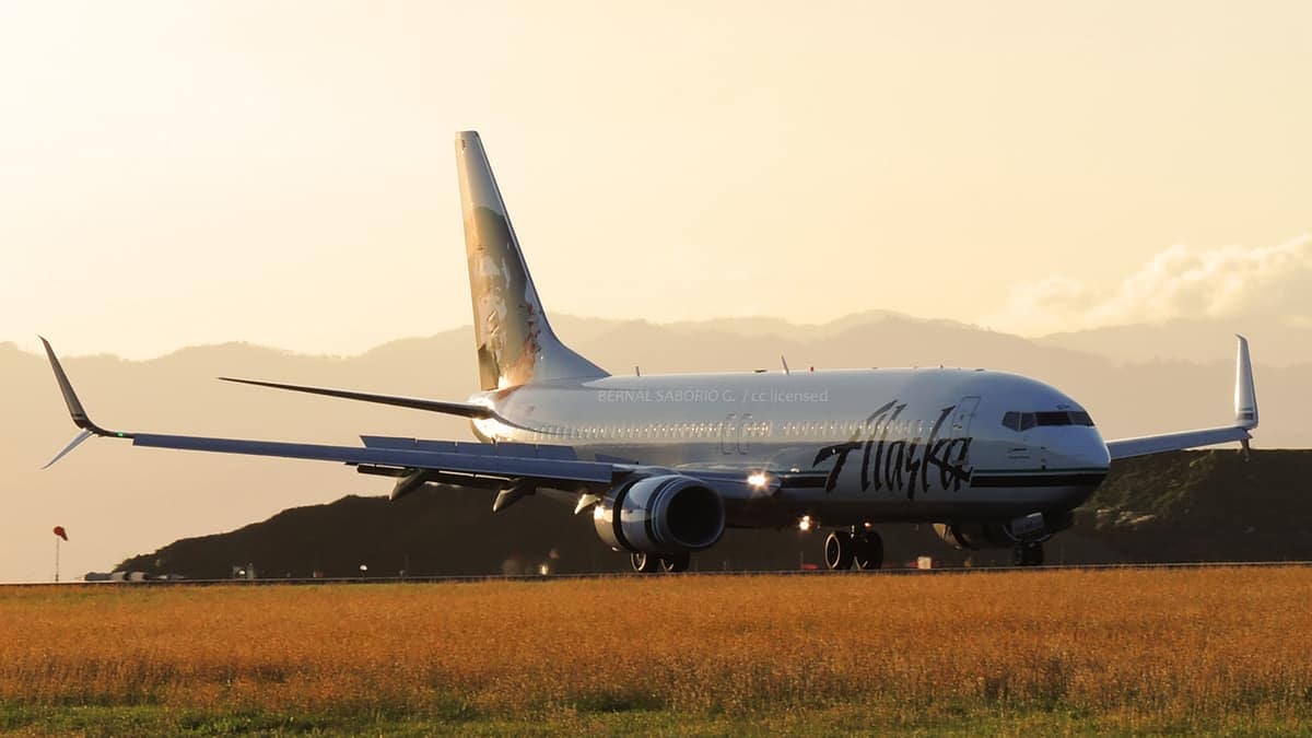 Alaska Airlines jet on the tarmac at sunset