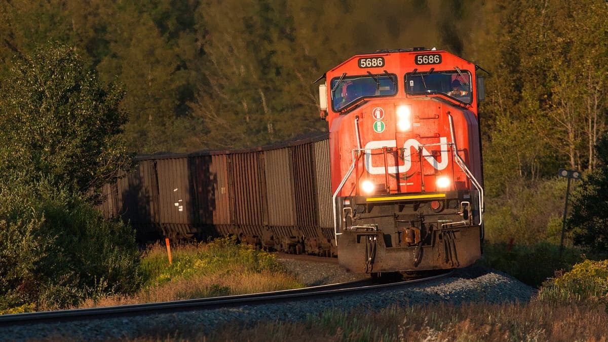 A photograph of a train locomotive hauling railcars.