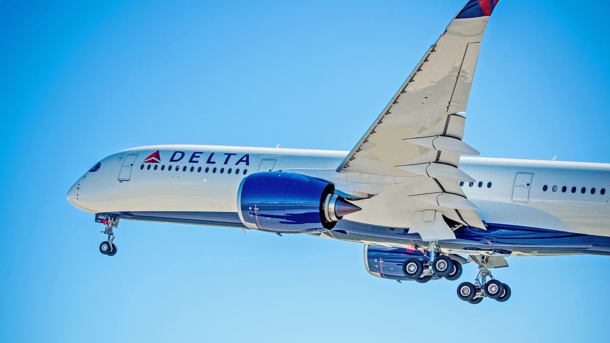 A Delta jet with its wheels extended in flight