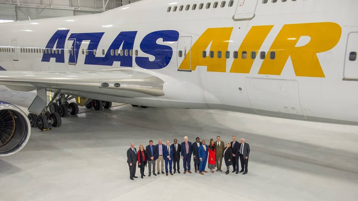 VIPs lined up under an aircraft wing