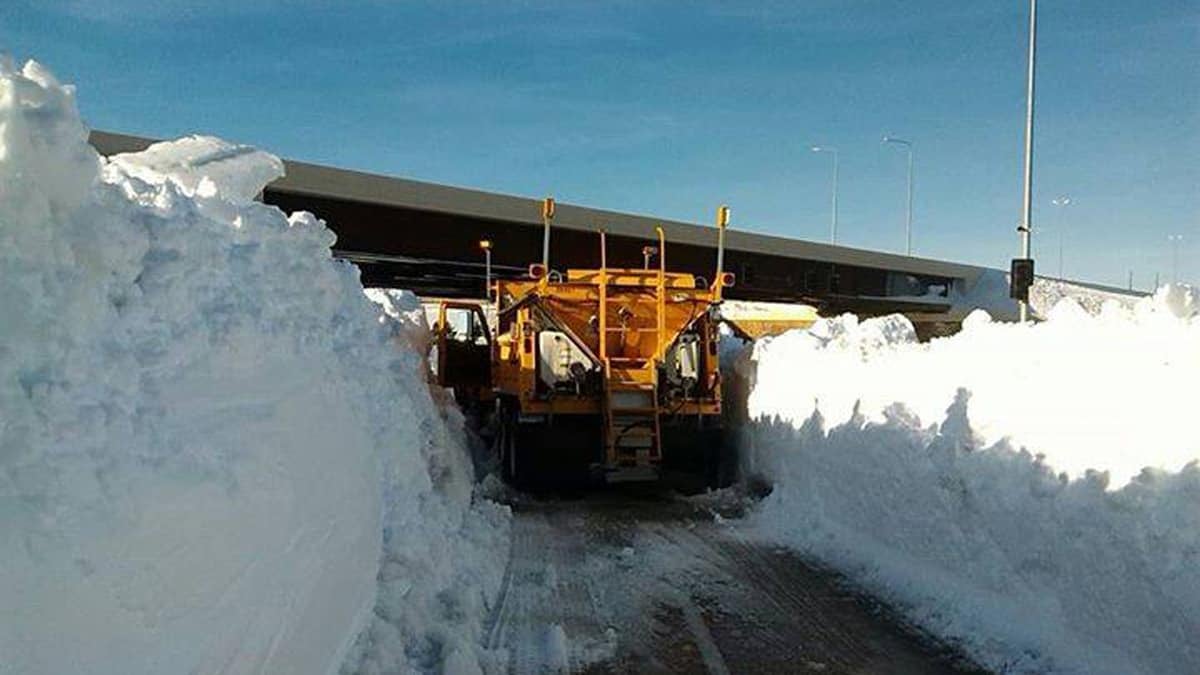 Plow clearing very snowy road in South Dakota.