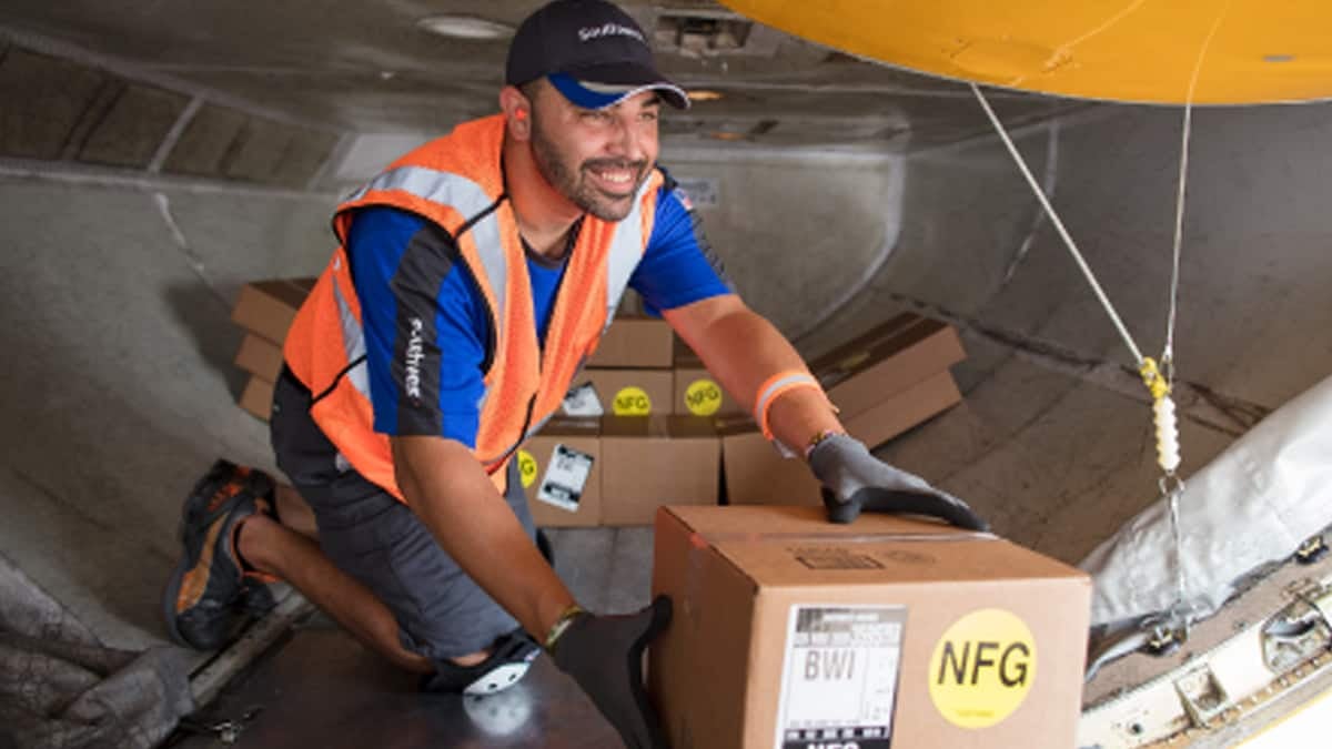 Guy working in cargo bay of plane