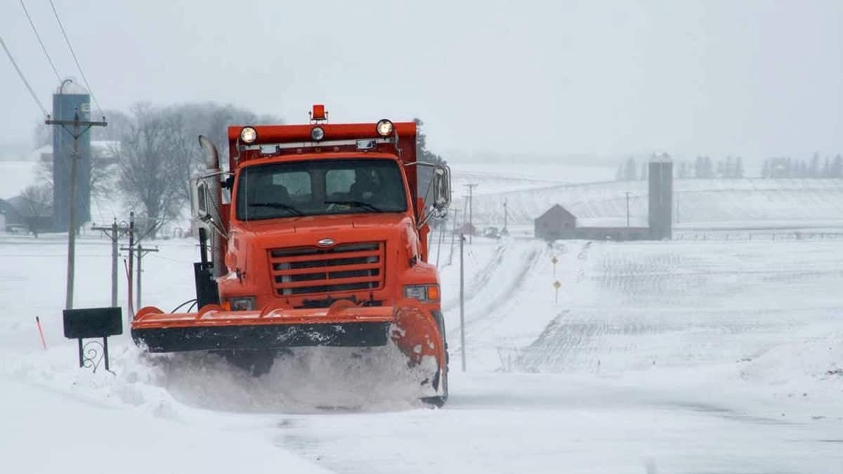 Plow on snowy Wisconsin highway.