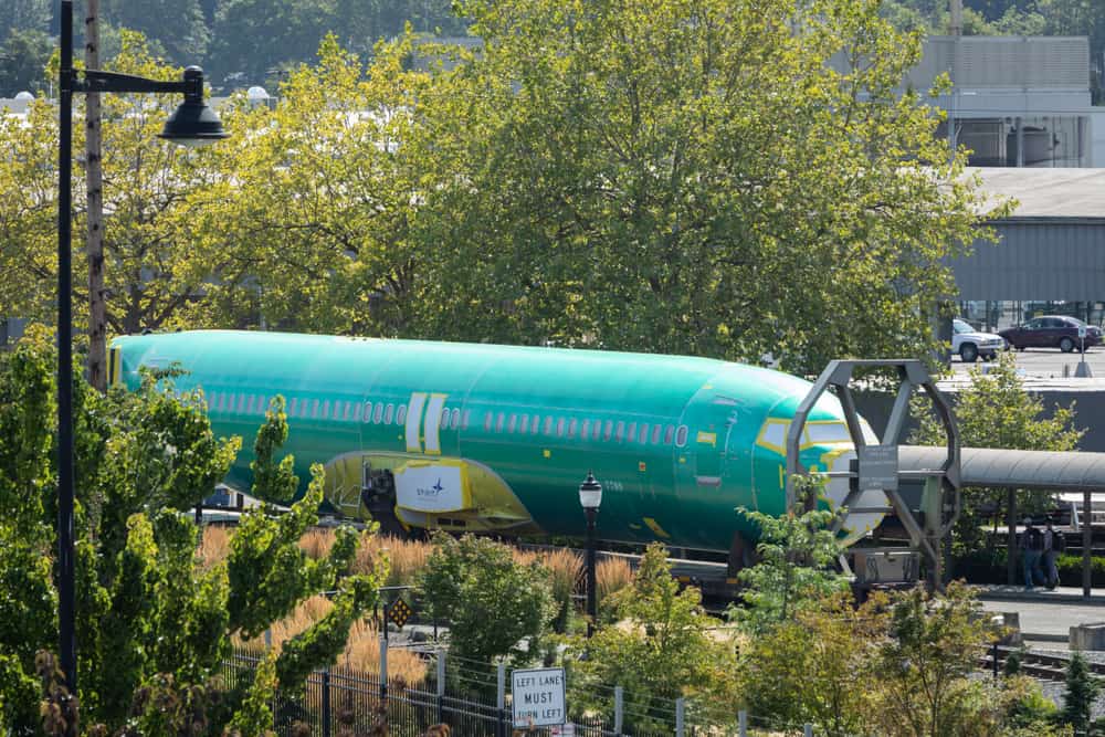 A 737 MAX fuselage waiting outside to enter factory.