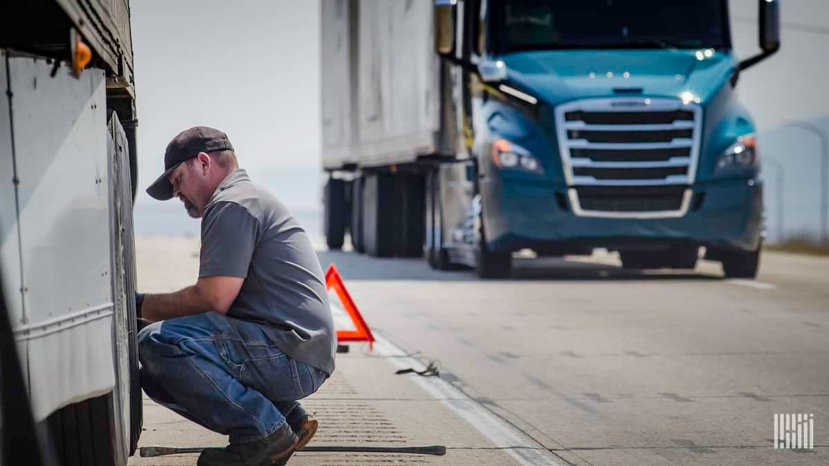 Worker repairing truck