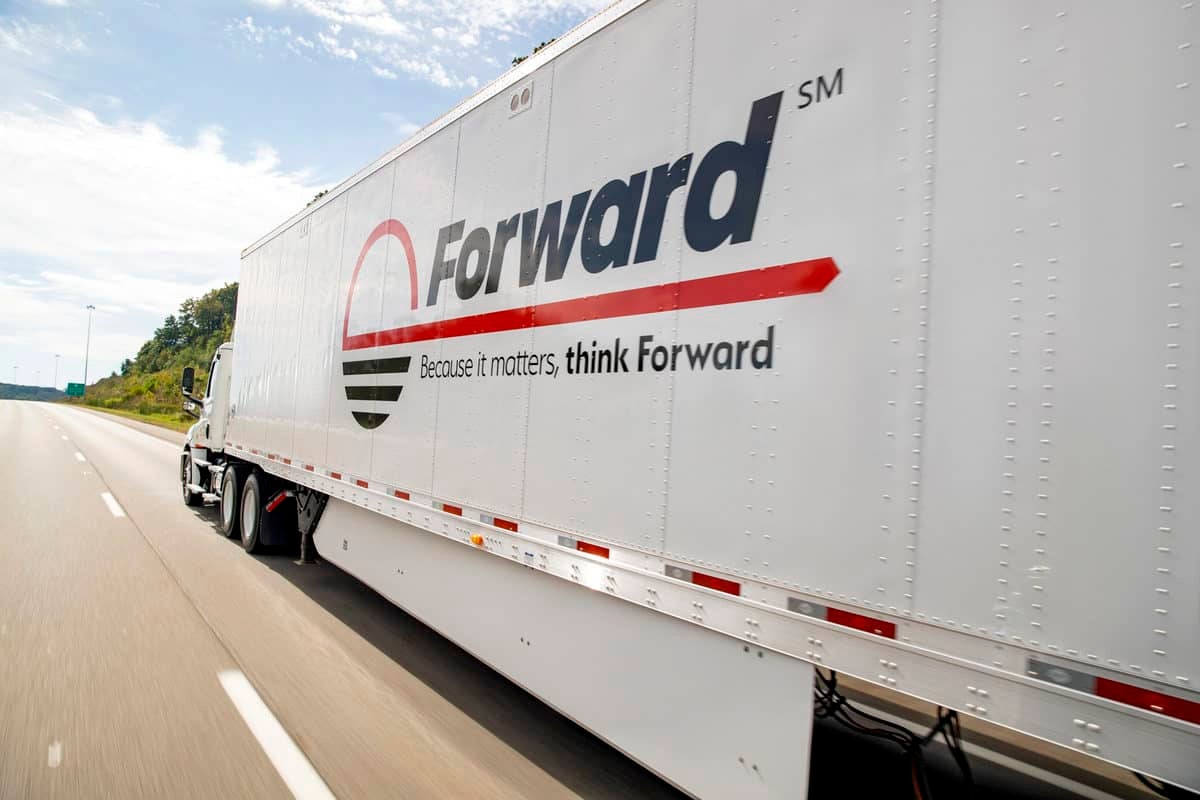 Side view of white truck running down the highway