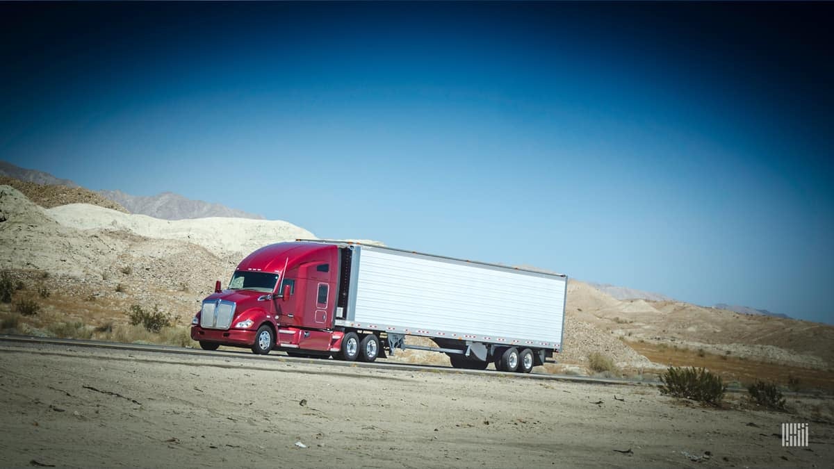 Truck drives down road in the desert