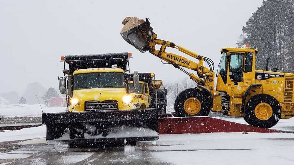 Plow clearing snowy road in North Carolina.