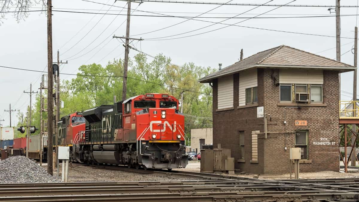 A photograph of a train next to a building.