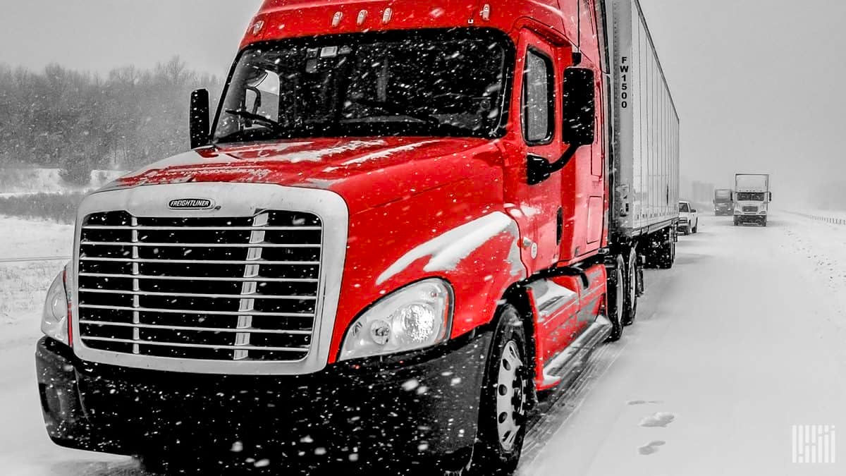 Tractor-trailers on snowy road.