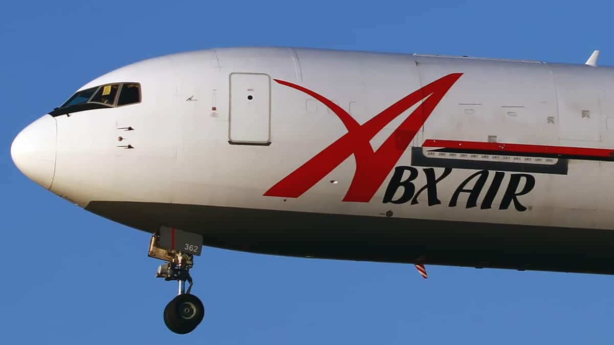 Close up of white cargo jet, front end, in flight