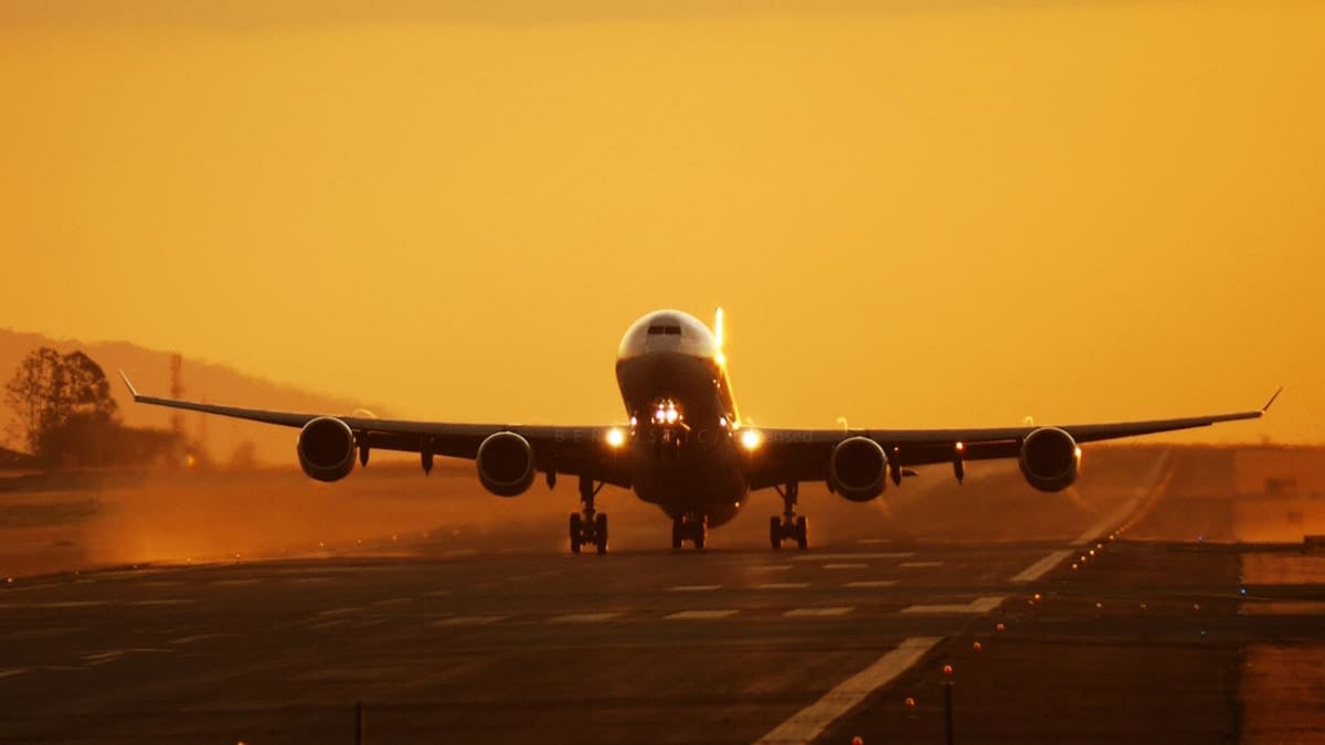 Plane landing in sunset