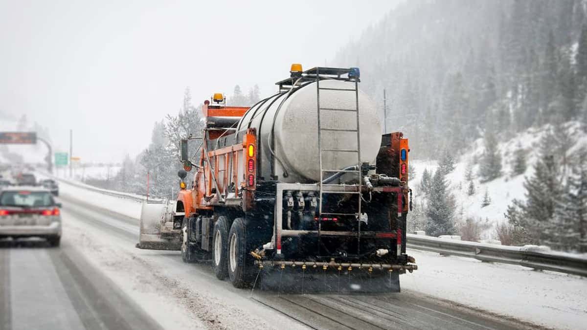 Plows clearing snowy Colorado highway.