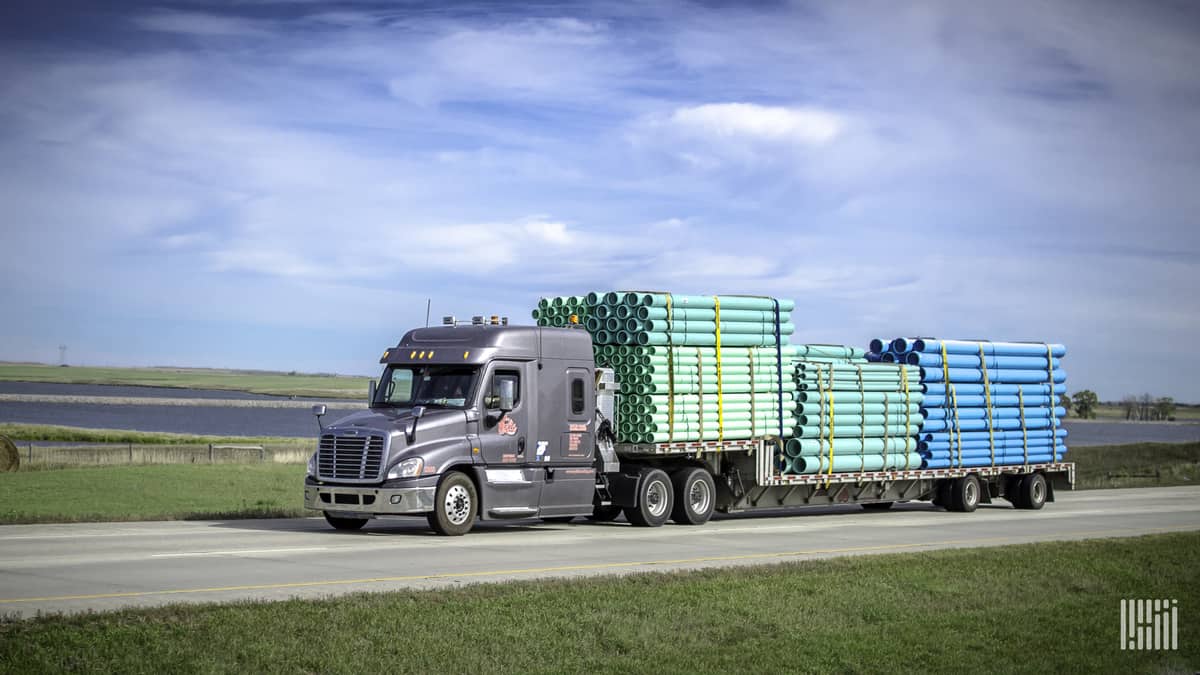 Daseke loaded flatbed rig on highway