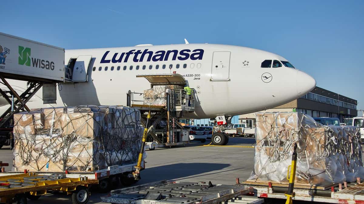 A Lufthansa plane gets loaded with cargo.