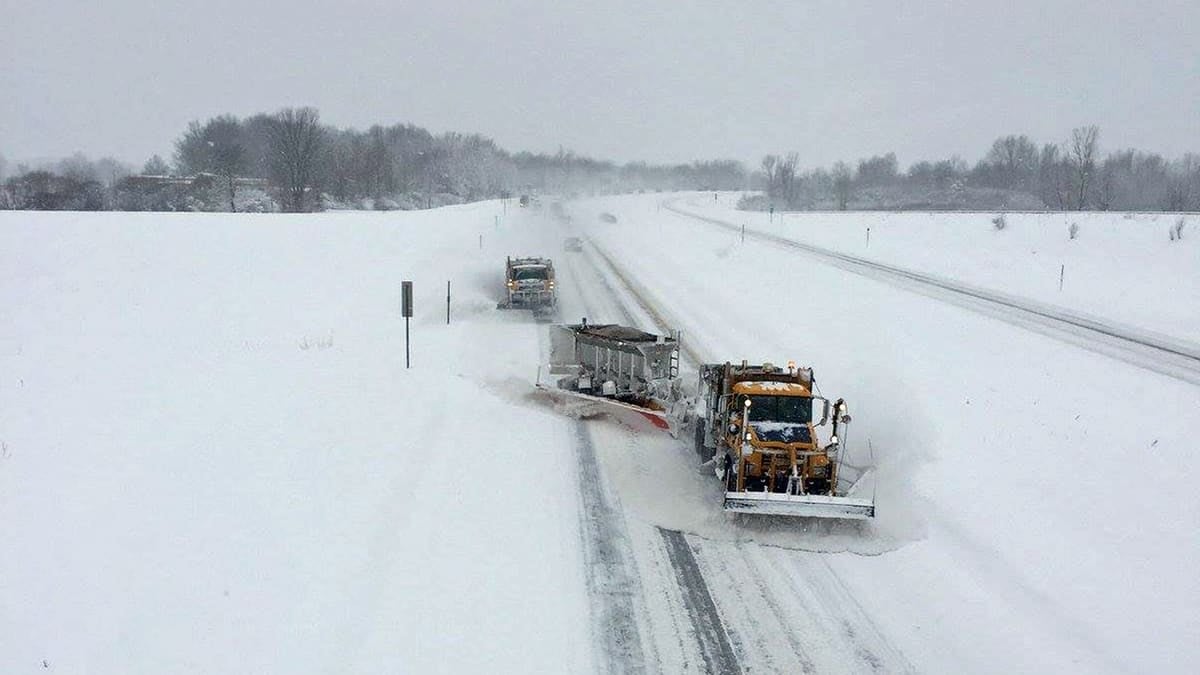 Plow clearing very snowy highway in New York state.