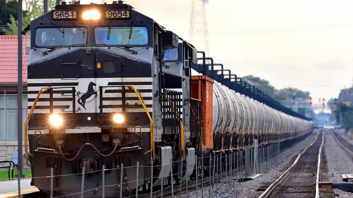 A photograph of a train nearing a rail yard.