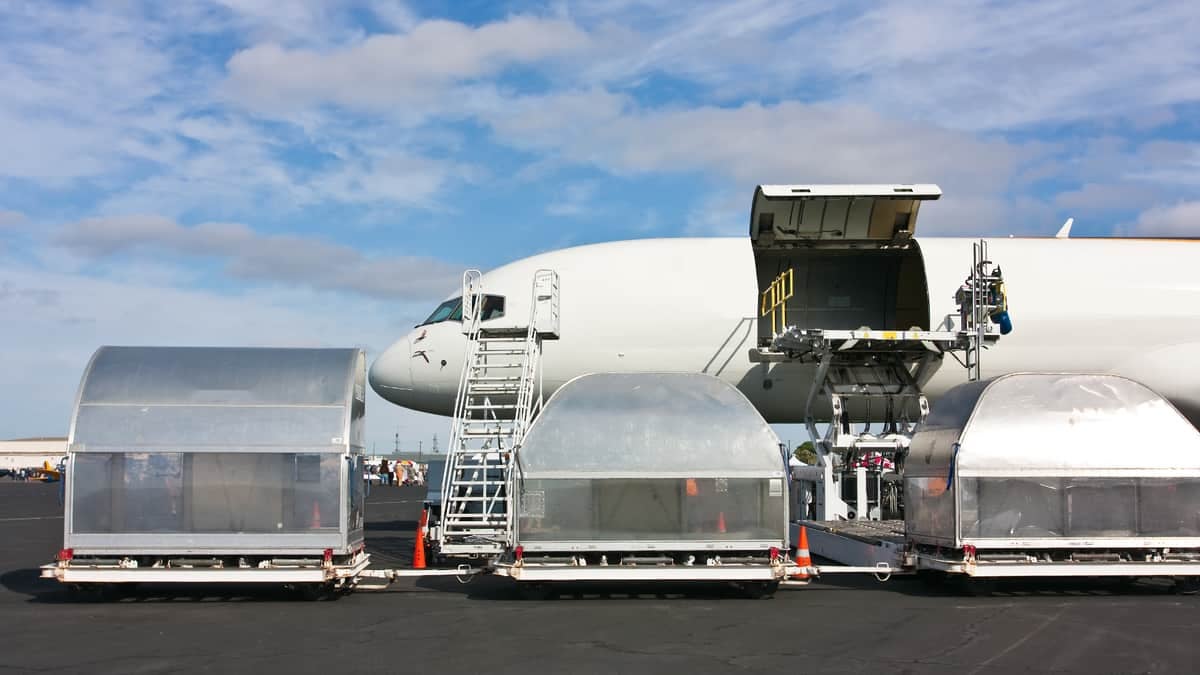 Air freighter and cargo pallets on tarmac