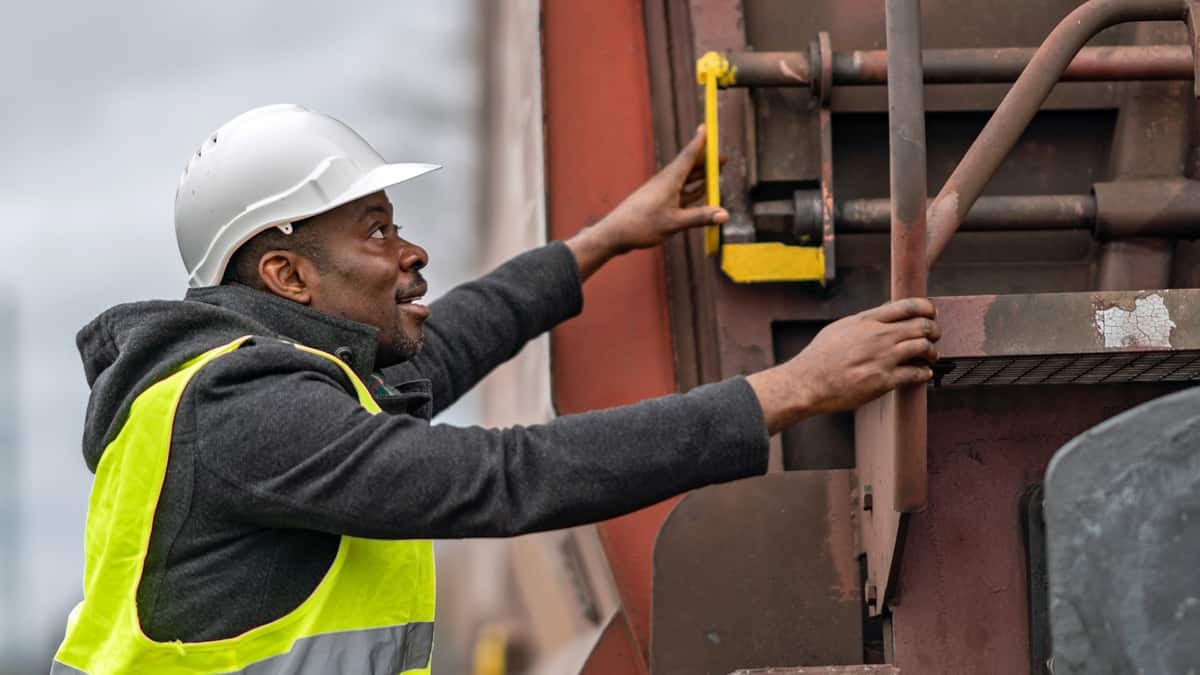 A photograph of a man inspecting equipment.