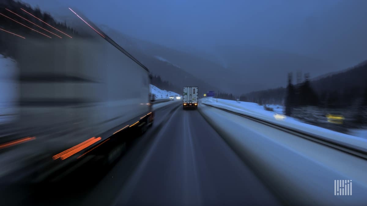 Tractor-trailers on slushy highway.