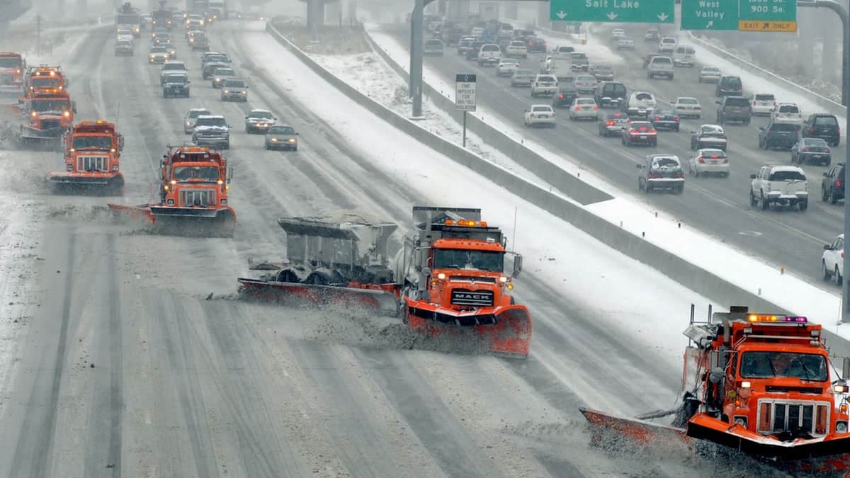 Plow clearing snowy Utah highway.