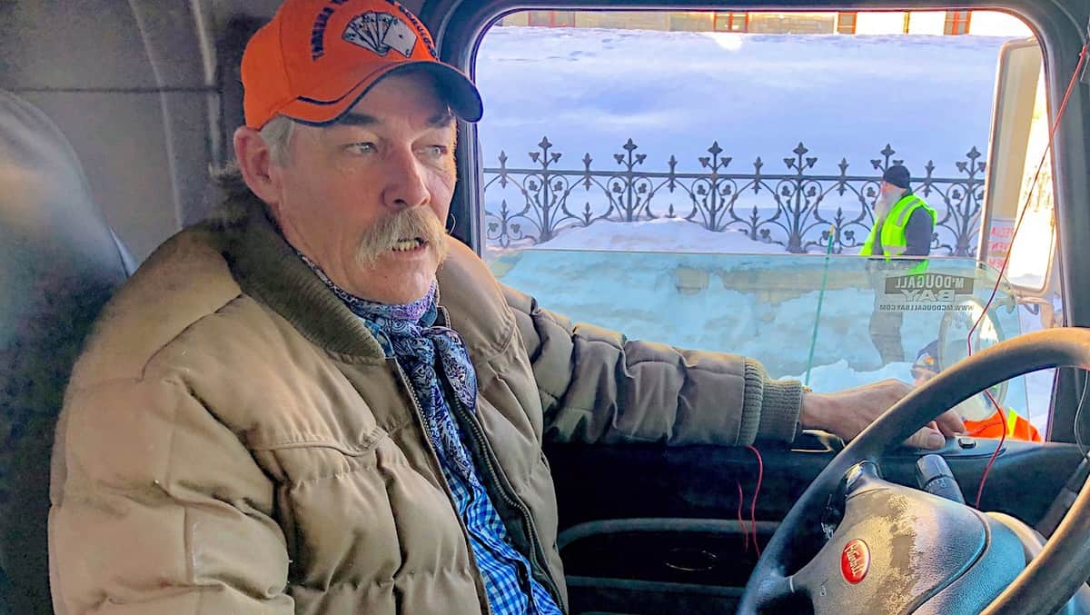 A truck driver in his rig in Ottawa, Canada.