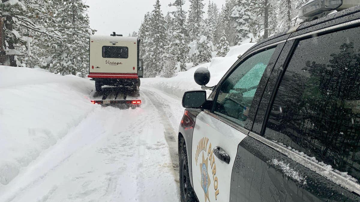 Highway patrol truck on snow California road.