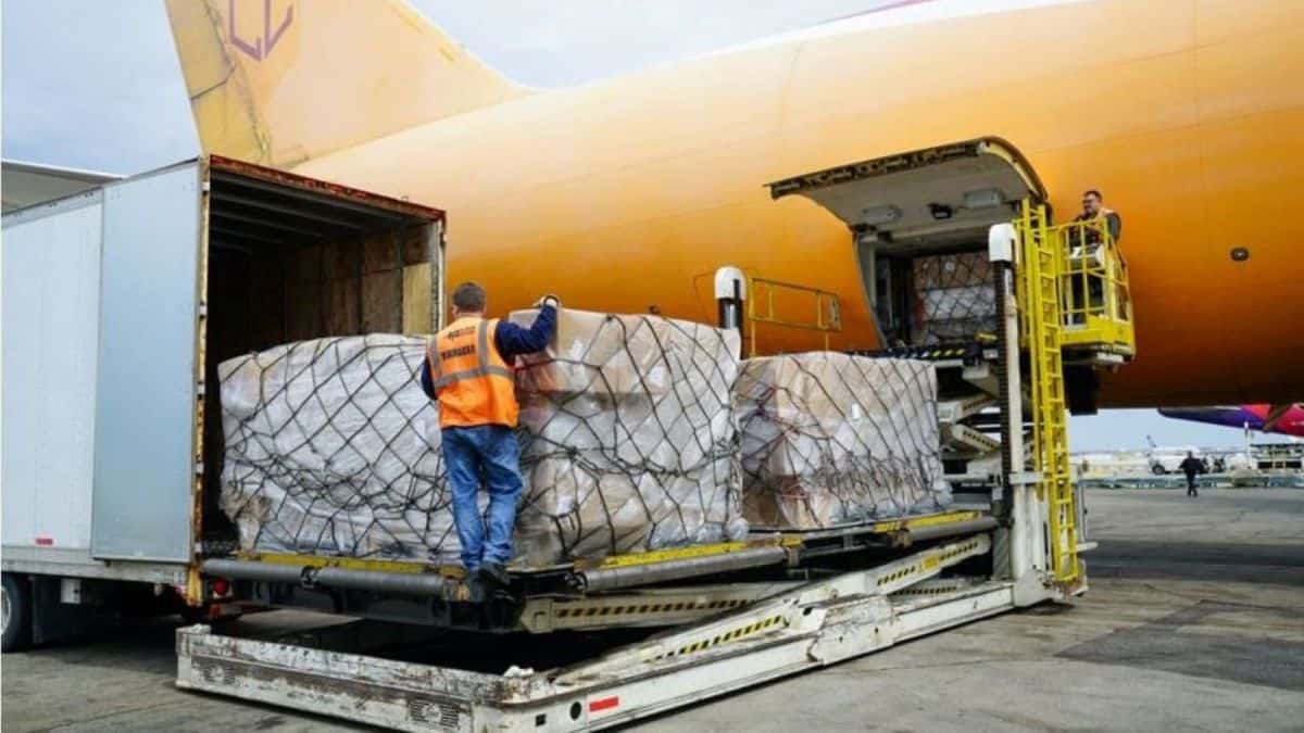 A yellow cargo plane is unloaded.