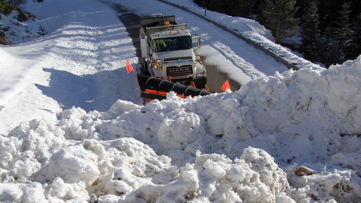 Plow clearing very snowy Idaho highway.