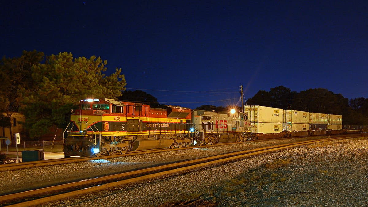 A photograph of a train taken at night.