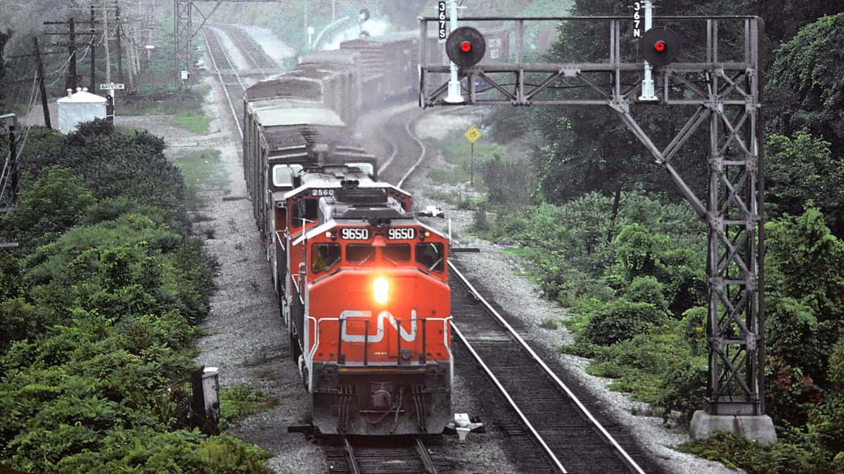 A photograph of a train hauling railcars.