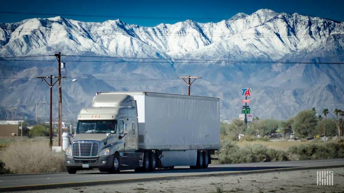 Truck with TA sign in background