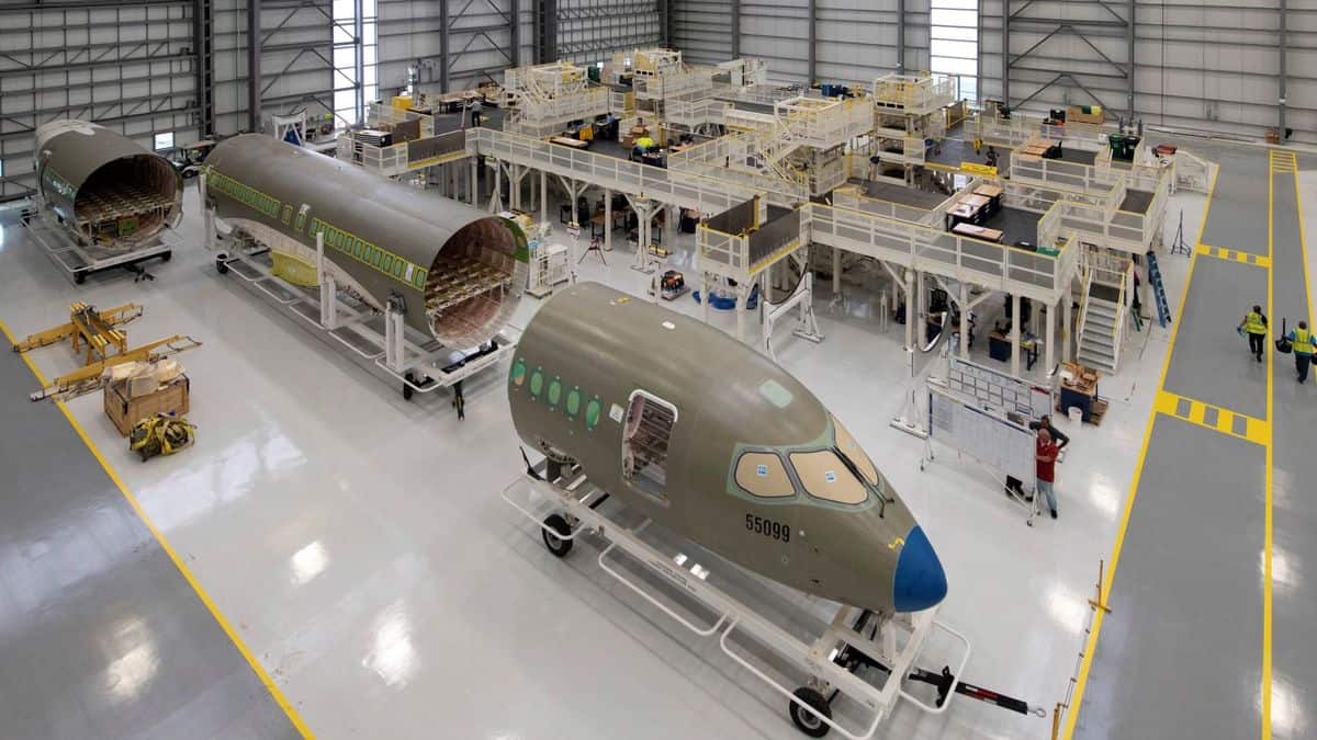 Partially assembled sections of a plane in a factory.