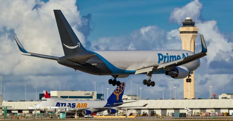 Amazon Prime Air plane comes in for landing at airport.