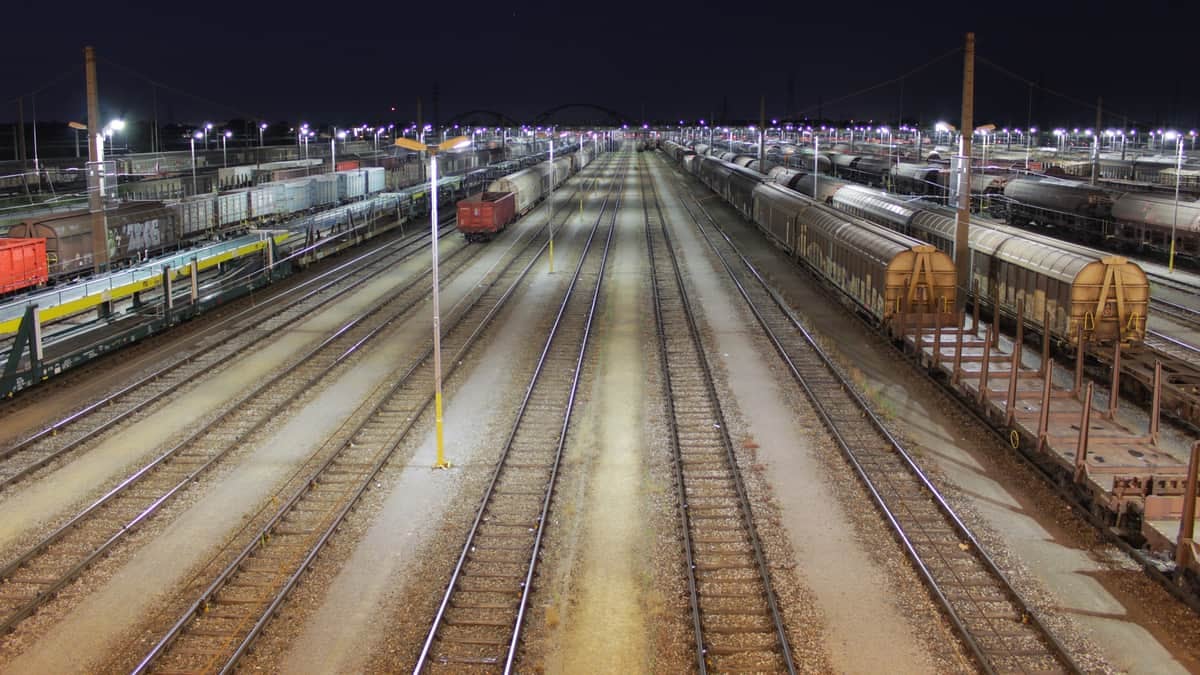 A photograph of a rail yard at night.