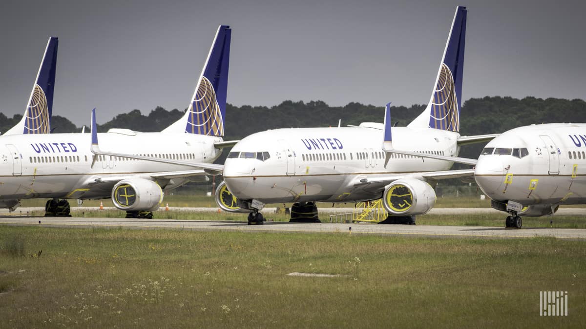 White planes with blue tails on the tarmac.