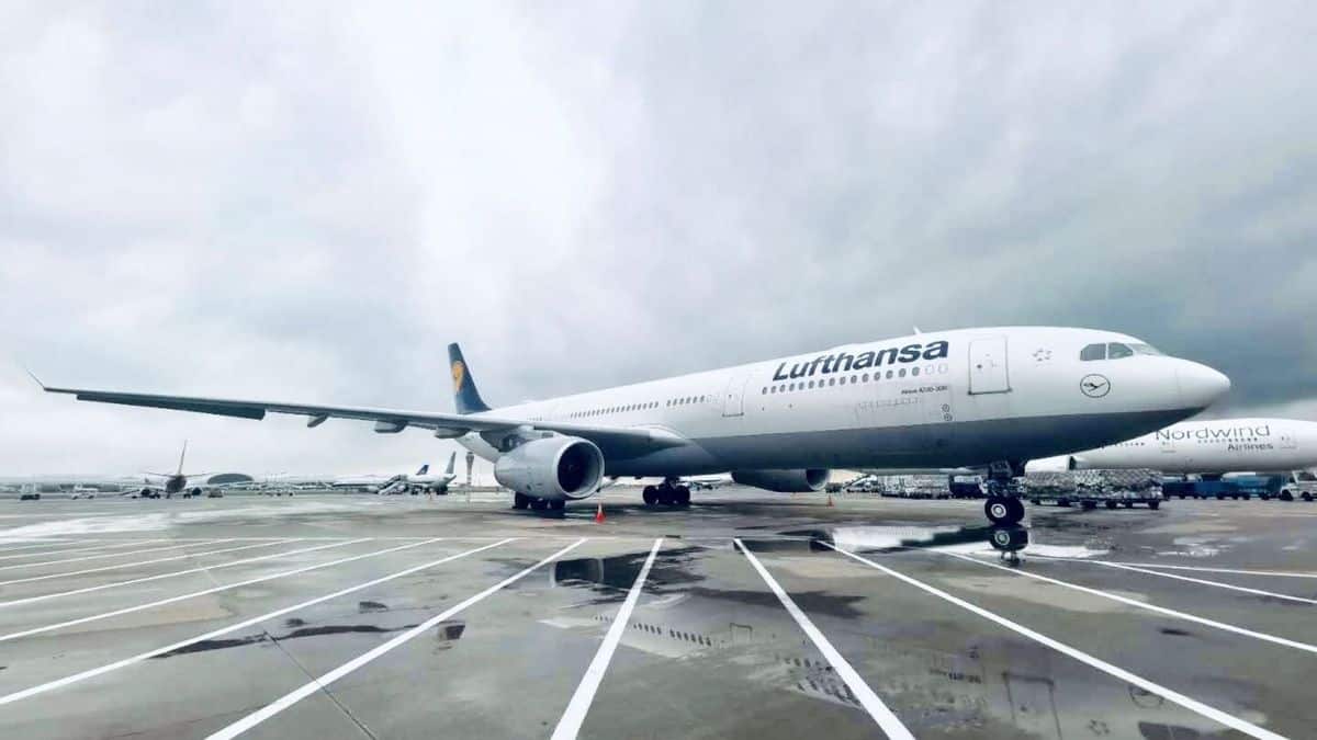 A white passenger jet, closeup view on the tarmac.