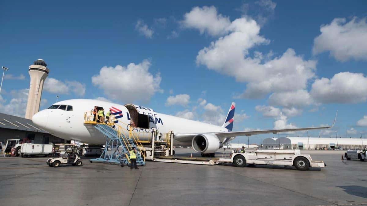 Cargo being unloaded from a large white cargo jet.