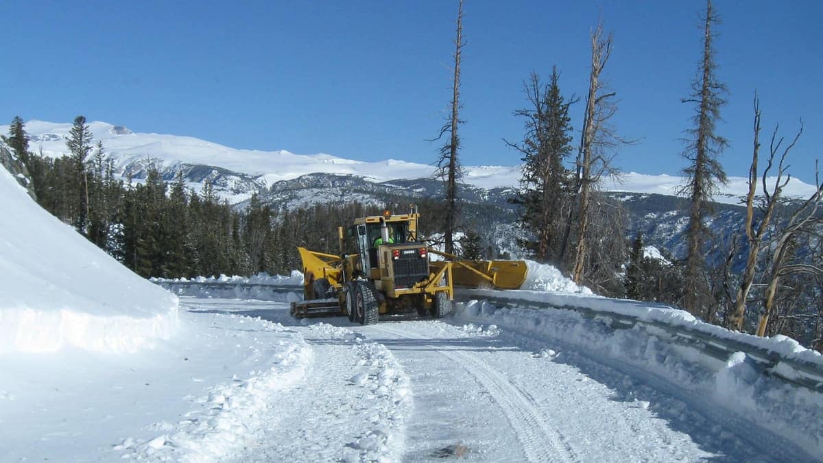 Plow clearing snowy highway in Montana.