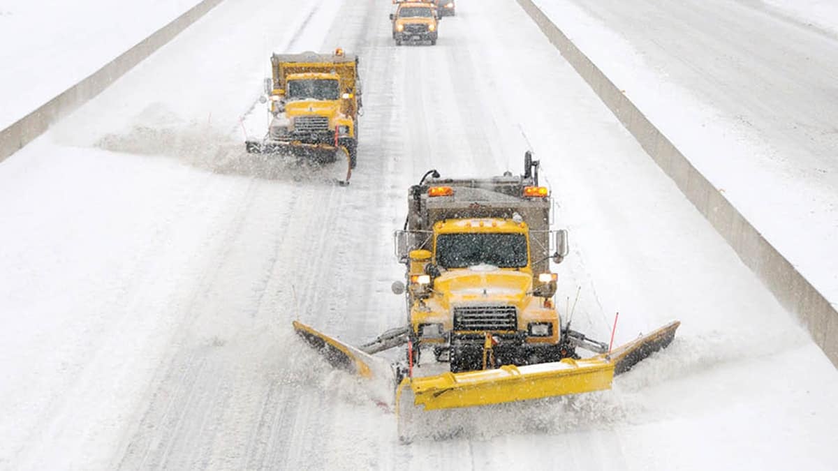 Plows clearing snowy Pennsylvania highway.