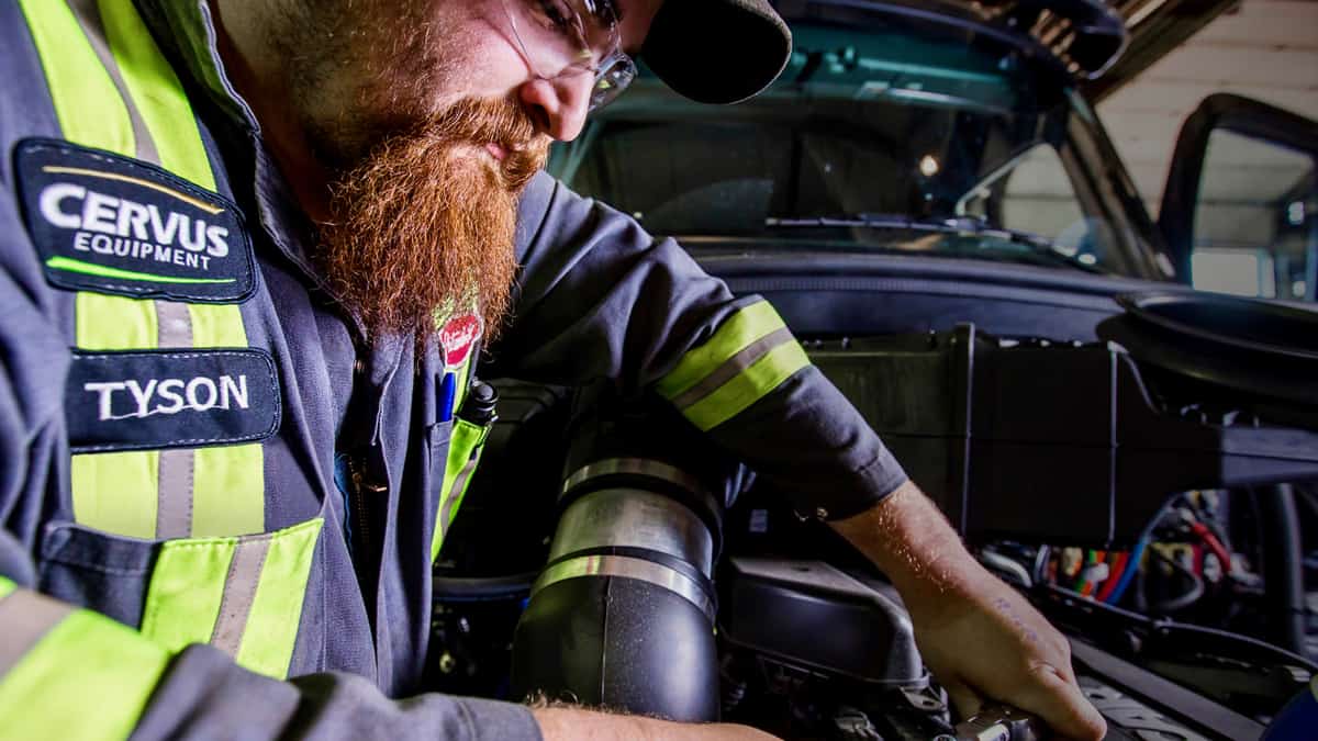 A Cervus Equipment mechanic works on a truck