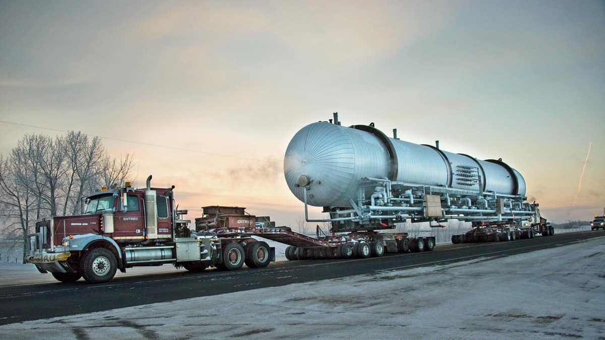 An ENTREC tractor hauls an oversized piece of equipment.