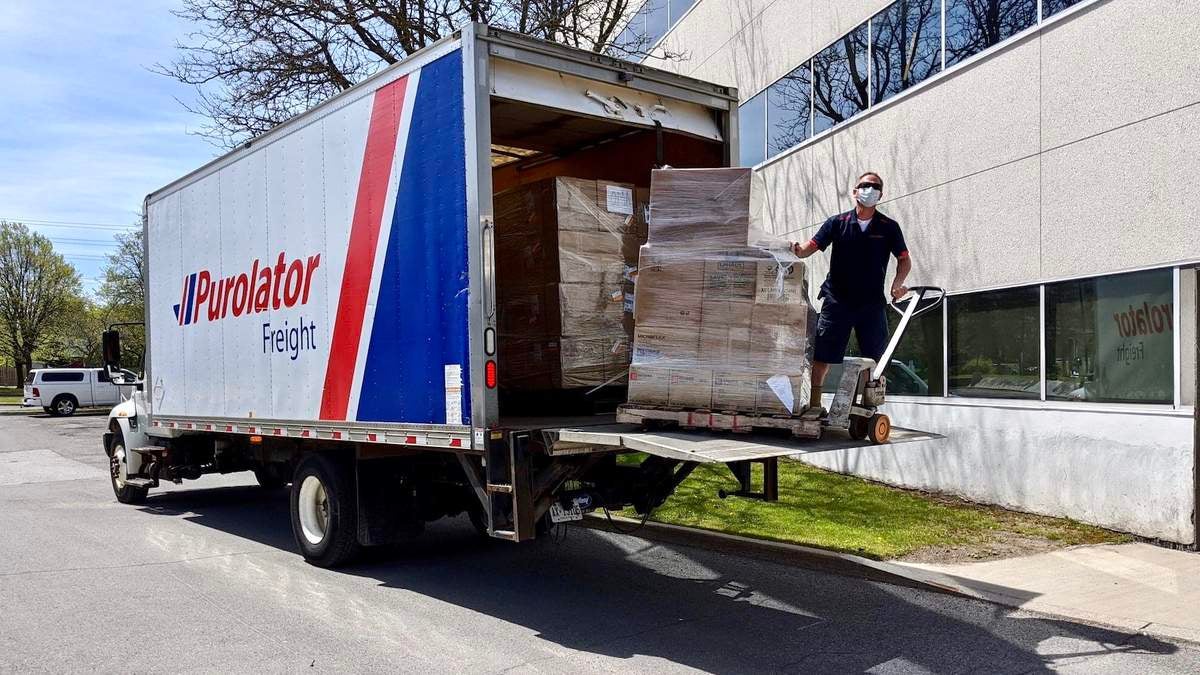 A Purloator driver making a less-than-truckload delivery