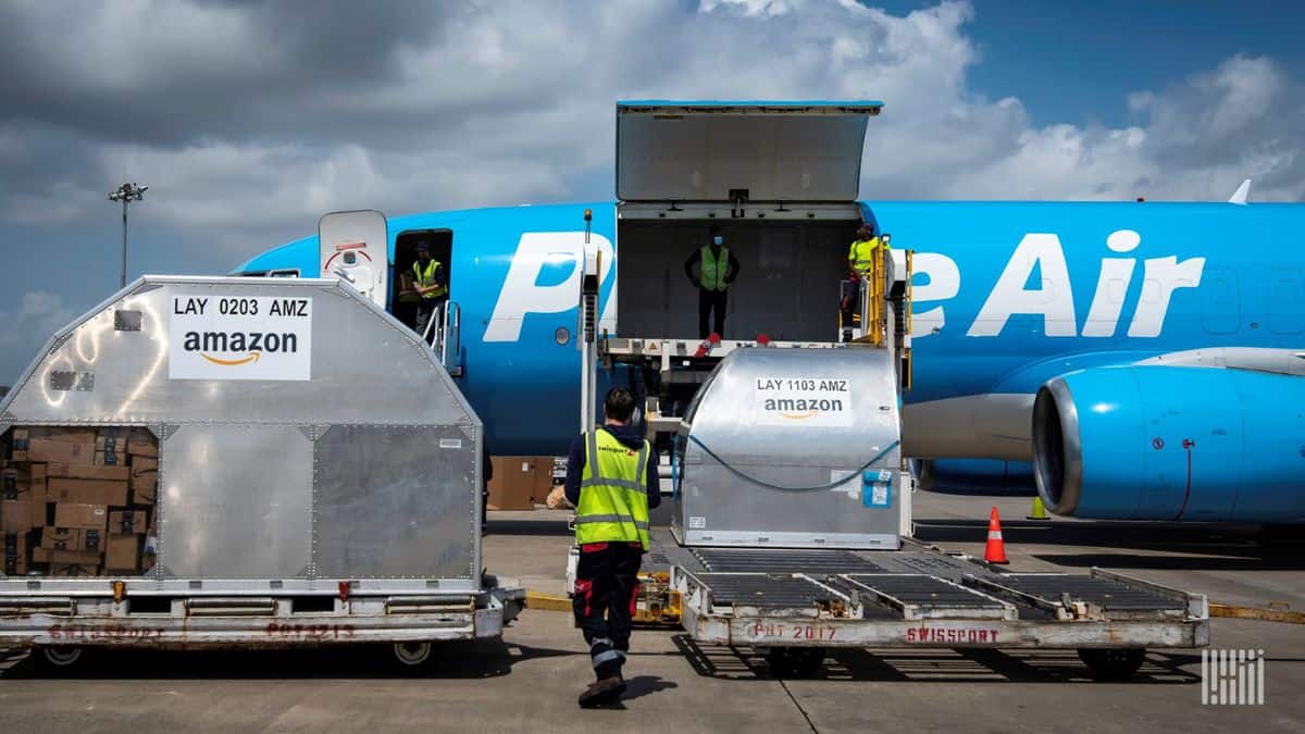 Light blue Amazon Prime plane with cargo door open, waiting for a load.