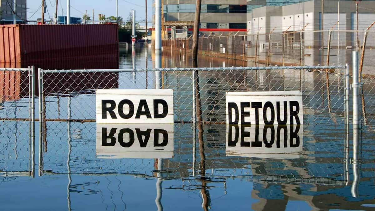 Flooded road with "Road Closed" signs.