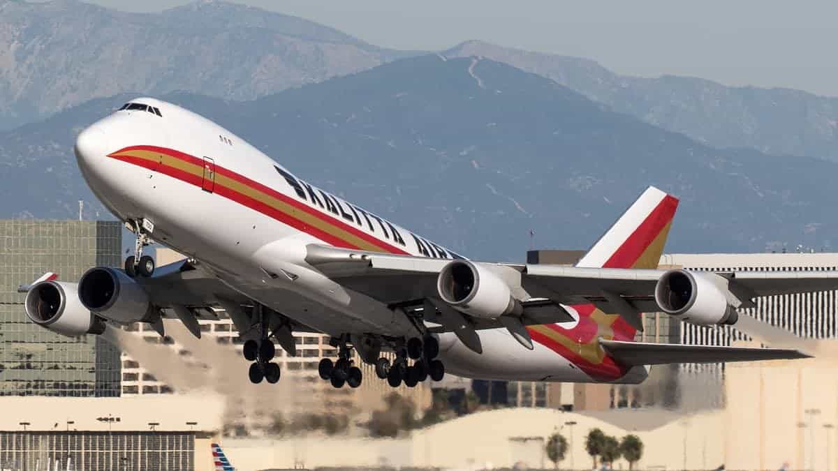 A big 747 jumbo jet takes off, nose up