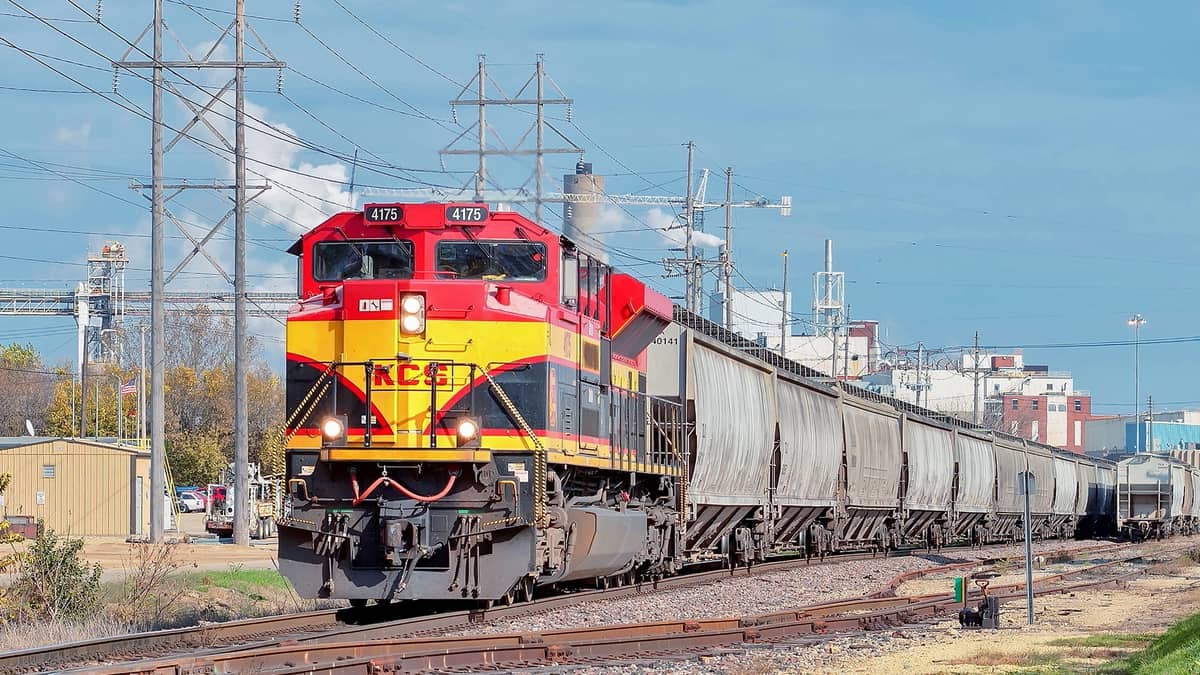 A photograph of a train hauling railcars.